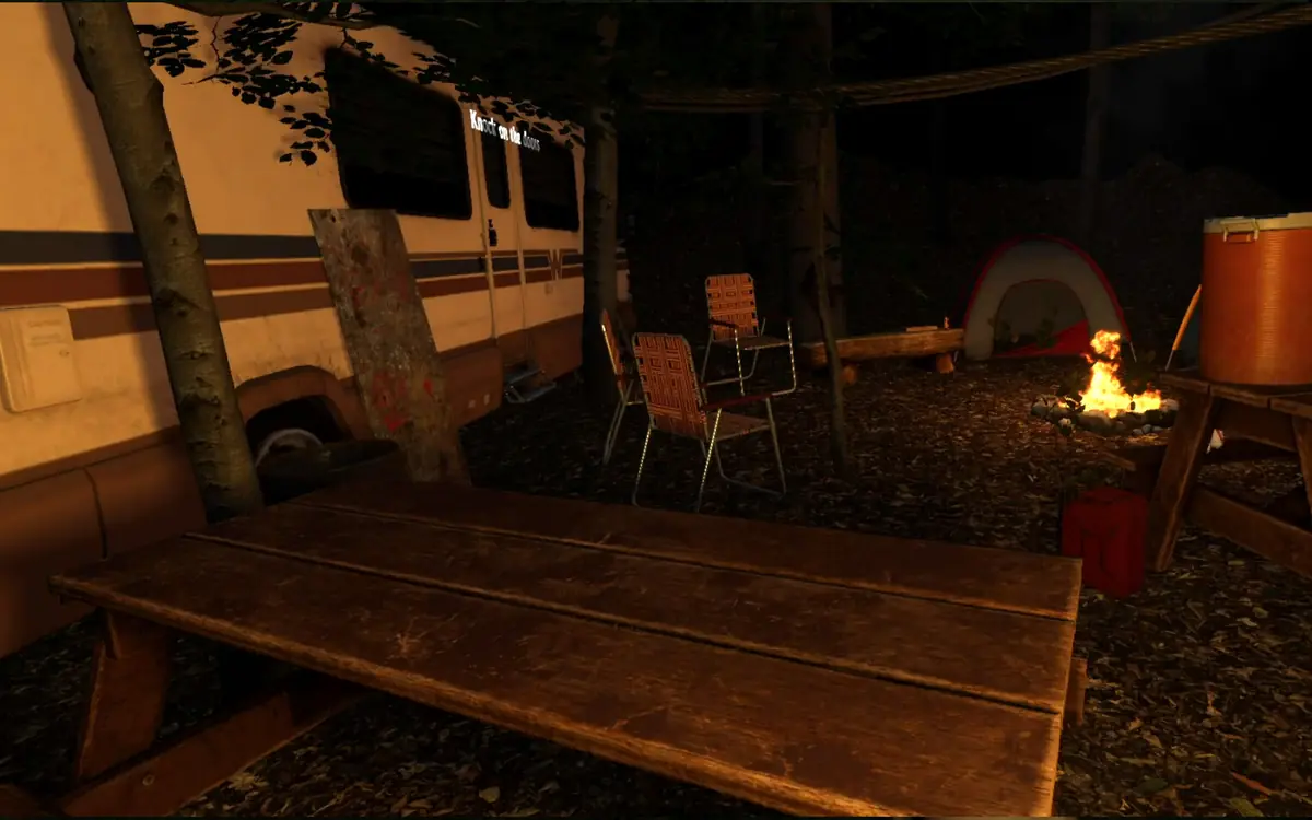 In-game screenshot of a firelit forest campsite at night with an RV, picnic table and tent